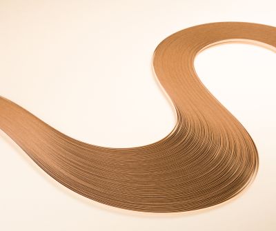 Gold brown colored s-shape curved paper stripes waves on golden background.